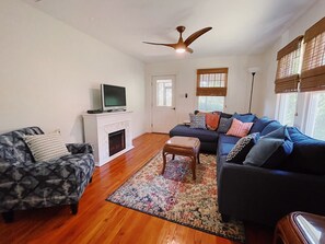 living room with queen size sofa bed sectional across from marble fireplace