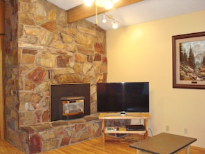 The beautiful stone fireplace adds a cozy touch to relaxing after a day of fun.