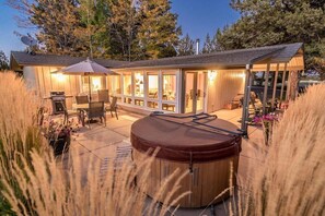 Exterior view with wrap around private patio, hot tub, adirondack rocking chairs, gas grill