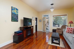 Chandeliers and local art provide a touch of elegance to the living room.