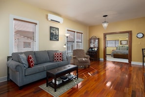 The living room is spacious with plenty of seating and hardwood floors.
