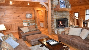 Great Room with Comfortable Furniture, Wood Burning Fireplace, and TV
