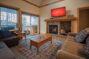 Cozy living room steps to back deck with hot tub and deep seating patio furniture to escape the heat in summer. 