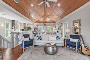 Great room, pecky cypress, quartz bartop, porches, treetop views, coastal vibes.