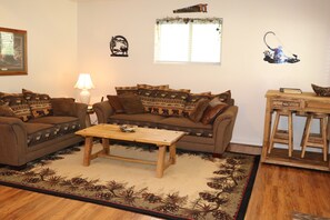 Living area with hide-a-bed sofa sleeper and dinette table and stools