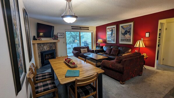 Condo H-3 Living room with gas fireplace, sofa bad, and balcony w/ gas BBQ grill