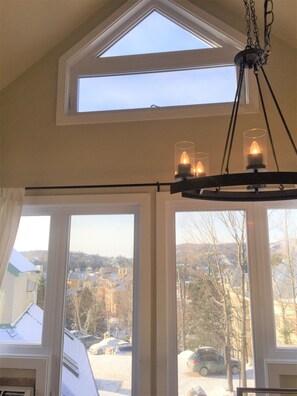 Kitchen window (parking spot where you see car)