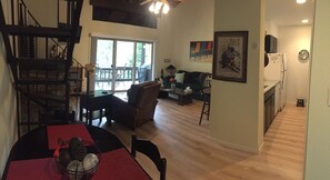 View from the top of the stairs with the kitchen on the right.
