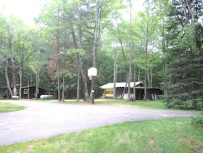 Driveway with basketball hoop and open area