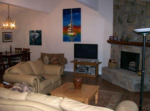 Open Great Room with 15' vaulted ceilings, oil on canvas art, rock fireplace