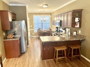 Fully-appointed kitchen with dining table and chairs.
