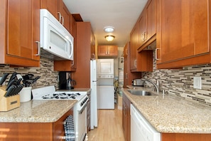 Fully stocked kitchen with dishwasher, microwave and washer/dryer.