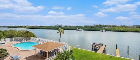 Balcony view of pool, fishing/boat docks, and peaceful Intracoastal waters