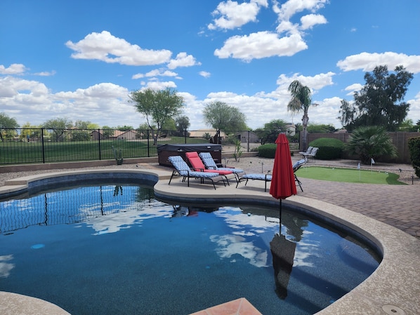 Backyard with pool and spa. The golf course is directly behind the fence.