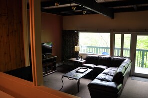 Living room with fireplace and deck