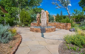 The front courtyard is surrounded by custom walls built by a master stonemason.