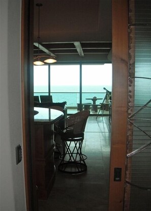 Step outside of your private elevator into a spacious condo w/ beamed ceilings 