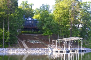 View From the water of dock, firepit and kayak rack