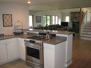 The open kitchen features a steel gas stove and lots of small touches.