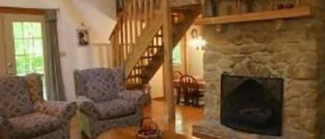 Fireplace in Living Room with Stairs to Bedroom