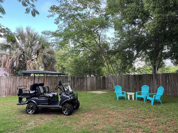 Beach house backyard with golf cart included in rental and covered patio