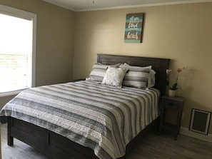 Lots of natural light in this queen bedroom with doggie door and large closet