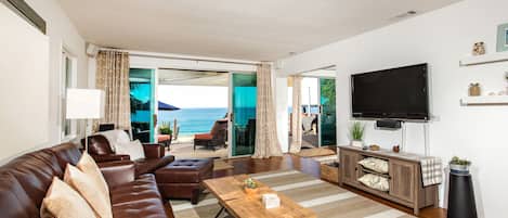 Watch tv in living room with an ocean view