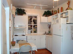 fully furnished kitchen with stained glass window