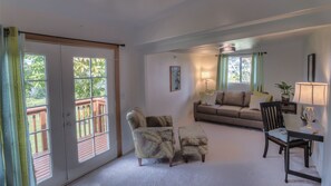 The living room is light and comfortable with HD TV and fireplace