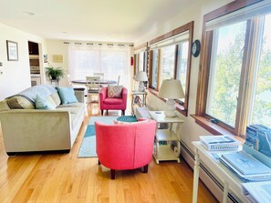 Living/dining area with sliding glass door to porch and panoramic views of sea