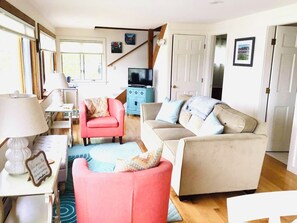 Living area, TV, doors to downstairs bedroom & bathroom