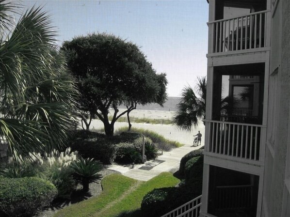 View of beach and ocean from screened in porch