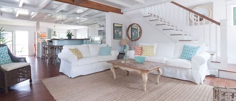 Gorgeous Beach house features sunny living room  with sofa, love seat and chair