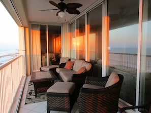 Comfortable balcony rattan furniture on half of 40 ft balcony.  Includes sofa.