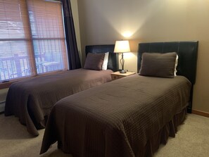 Second bedroom with XL twin beds, side table with USB connections