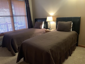 Second bedroom with XL twin beds, side table with USB connections