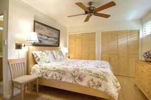 Larger bedroom with queen size bed and 
dresser.