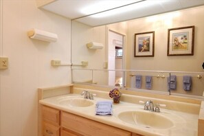 Bathroom with privacy door between the toilet & shower stall and two person sink