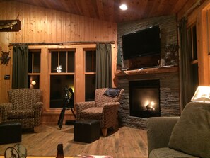 Living Room looks out onto lake, with gas fireplace and entertainment system.