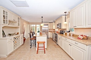 Kitchen is a great place to hang out or sit in the cushion topped bar stools.