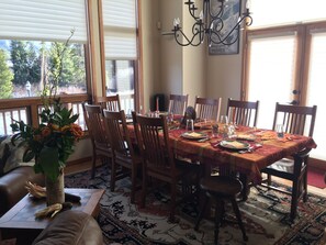 Table extends to fit 10 people with additional seating for 4 at the bar