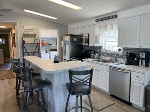Full size washer and dryer in pantry next to kitchen.