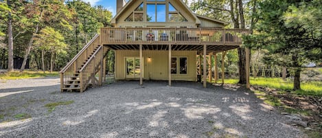 Fall view with parking area and driveway 