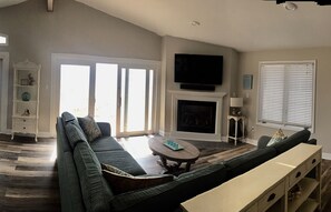 Renovated family room with gas fireplace overlooking the beach.
