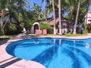 Margaritaville with palapa and huge pool in front of the house