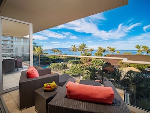 Unwind in plush outdoor seating while admiring panoramic ocean views and tropical landscapes on this luxurious lanai.