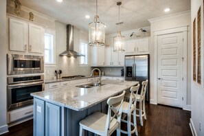 A Dream Kitchen super large island, gas burner stove, stainless steele appliances compliment the amazing granite countertops.