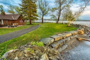 Front of house in early spring. East shore of Cayuga Lake in the distance