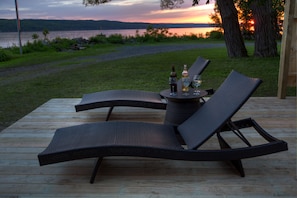 Loungers on the deck during a summer sunset