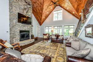 Stacked stone gas fireplace, cathedral ceilings, and beautiful mountain views